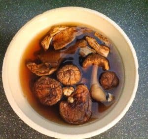Soaking dried shiitake and porcini mushrooms