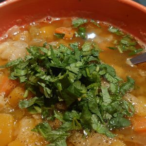 Root vegetables, green leaves and lentil soup